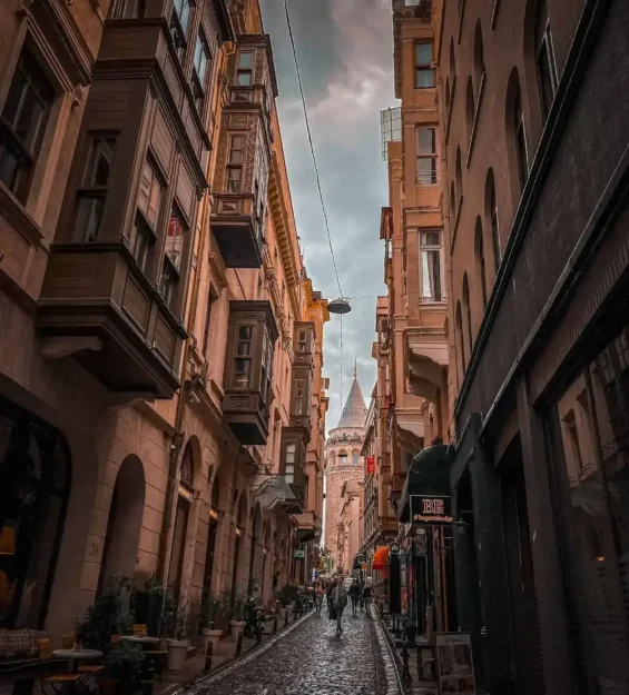 Galata'da dar sokak ve fonunda Galata Kulesi yükseliyor _by fotoloji