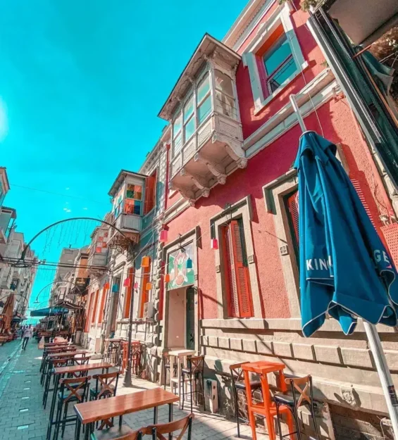 Açık hava kafeleriyle dolu bir sokakta sıralanan rengarenk Balat evleri _by fotoloji