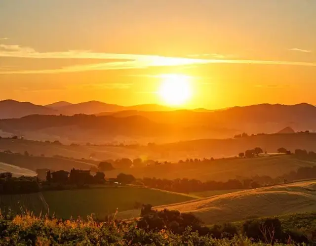 Sunset over rolling hills