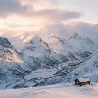 Dramatic winter landscape photography, snow covered mountains, soft light, high detail, cinematic mood.