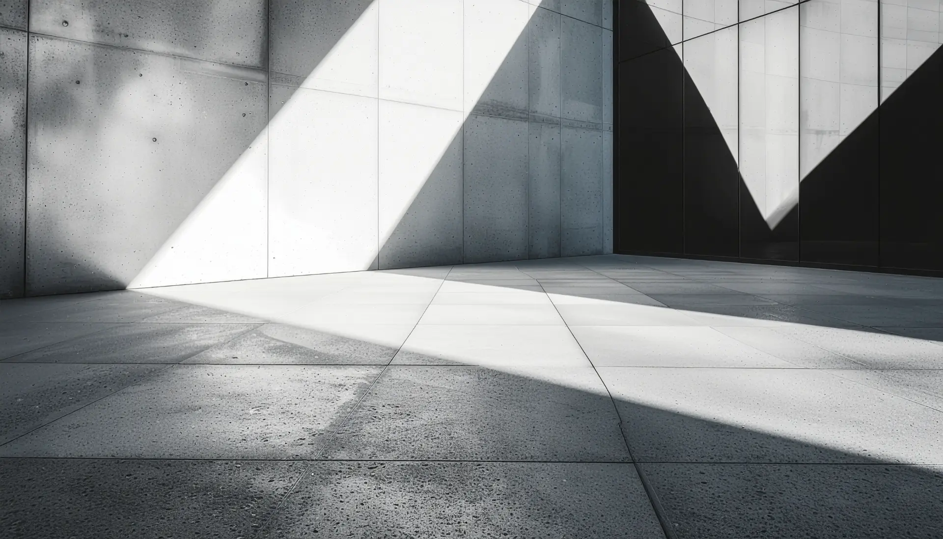 Abstract architectural detail close up of intersecting raw concrete planes and dark